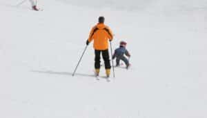 father and toddler skiing.