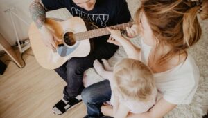 family singing and playing guitar.