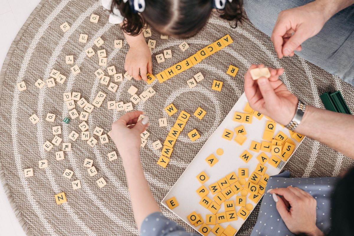 Parents and kids playing board games together during family game night.