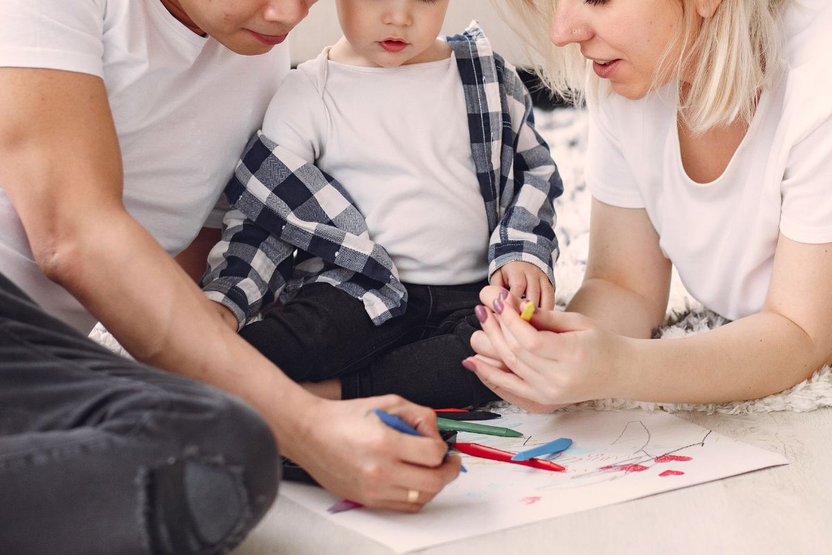Family drawing and coloring together during screen free activity at home.