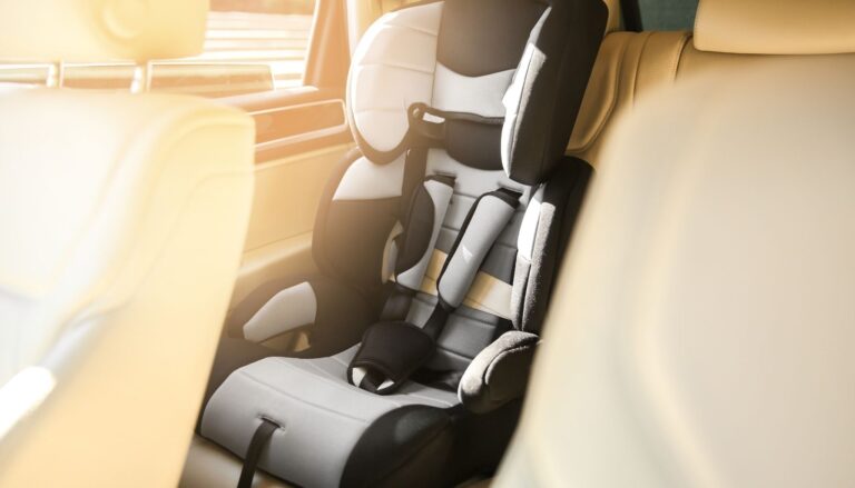 Child car seat installed in the back seat of a small car.