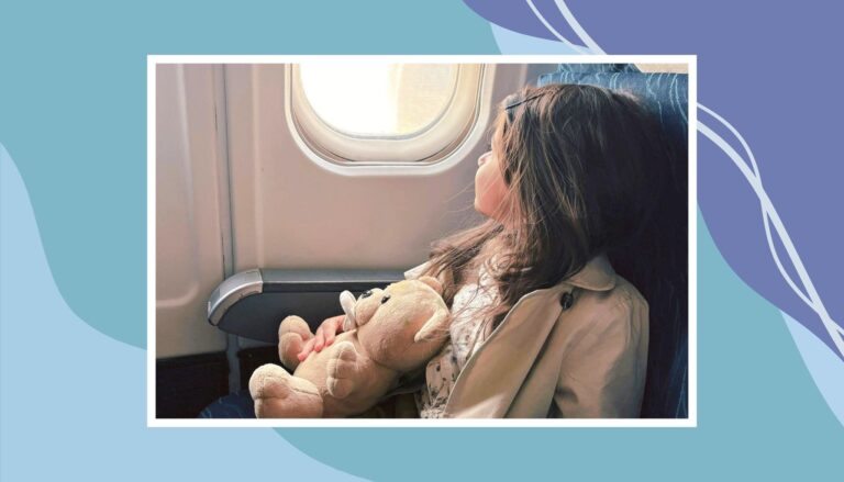 Child sitting by airplane window holding a teddy bear during a flight, capturing a calm moment while traveling with kids in Canada.