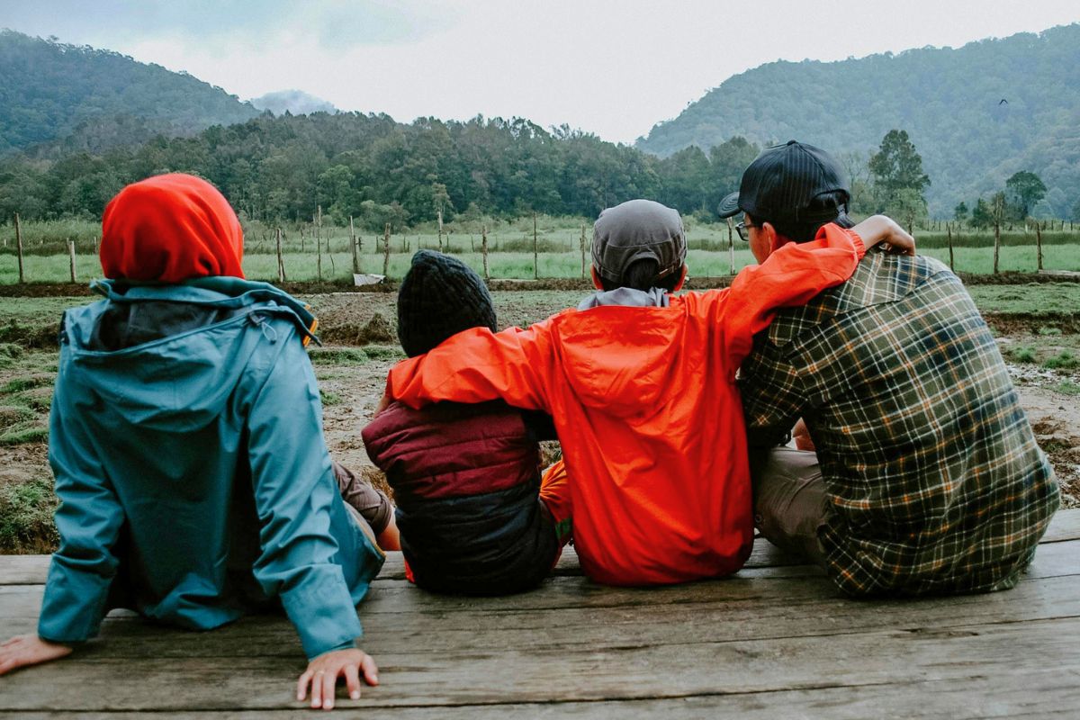 Family relaxing outdoors during a Canadian camping vacation.
