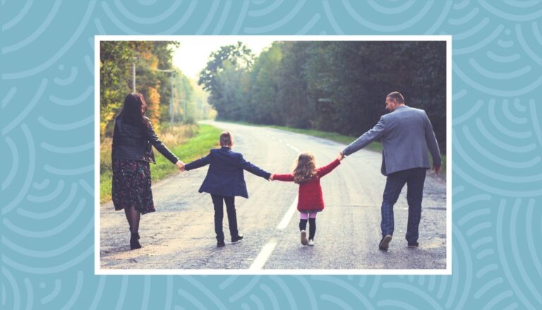 Family walking together on a scenic road during a family vacation in Canada.