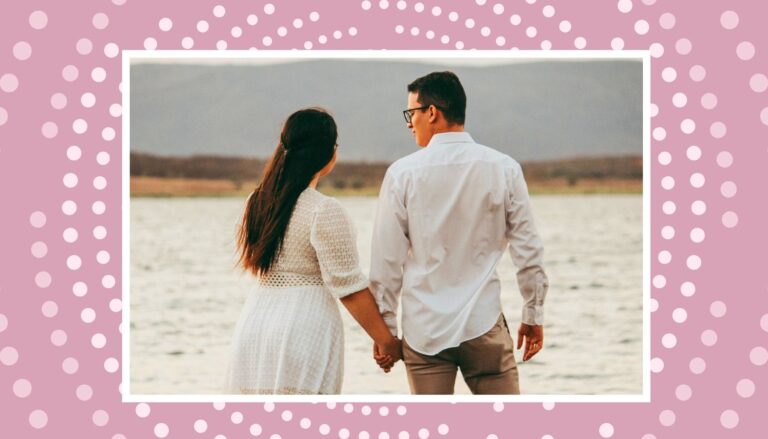 Expecting couple walking by the water for a calm babymoon before baby arrives.