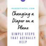 Parent holding a baby during a diaper change, showing a simple setup that reflects tips for changing a diaper on a plane.