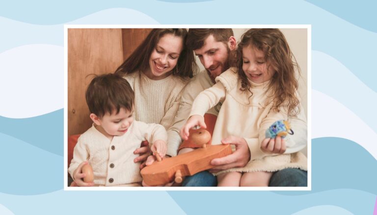 Parents and two children enjoying a screen-free family activity with wooden toys at home.