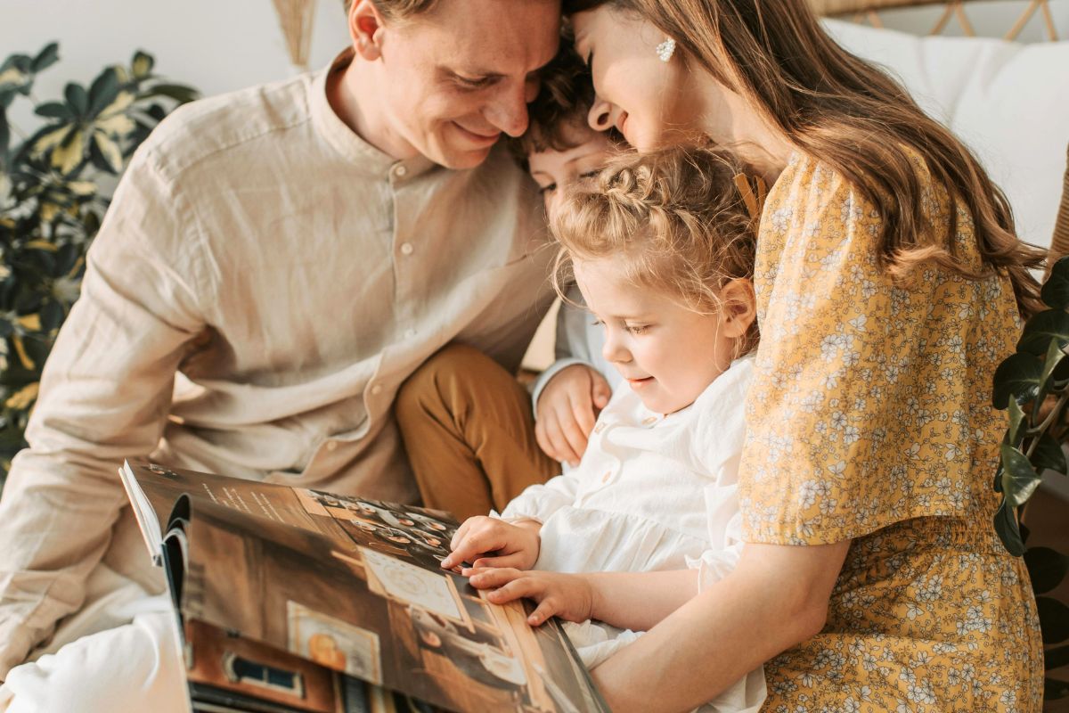 Family reading together at home before choosing a daycare that fits their child’s needs and routine.