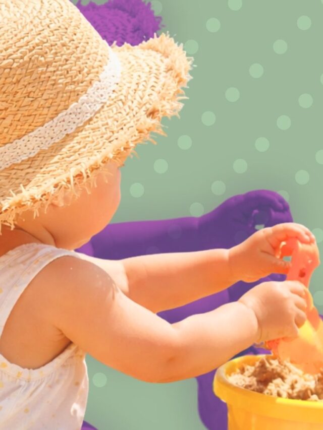 Toddler playing with sand toys by the beach, illustrating essentials for a beach vacation with toddlers.