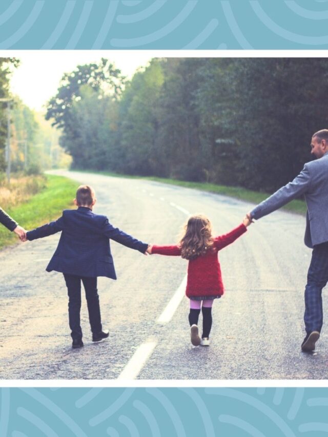 Family walking together on a scenic road during a family vacation in Canada.