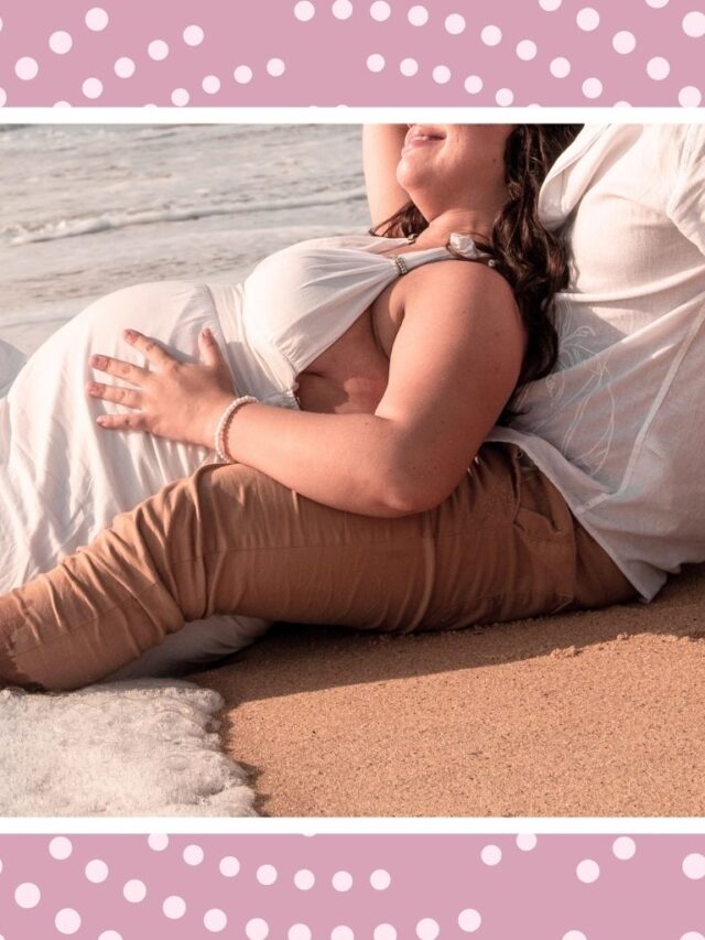 Pregnant couple relaxing on a beach during a romantic babymoon getaway in Canada.