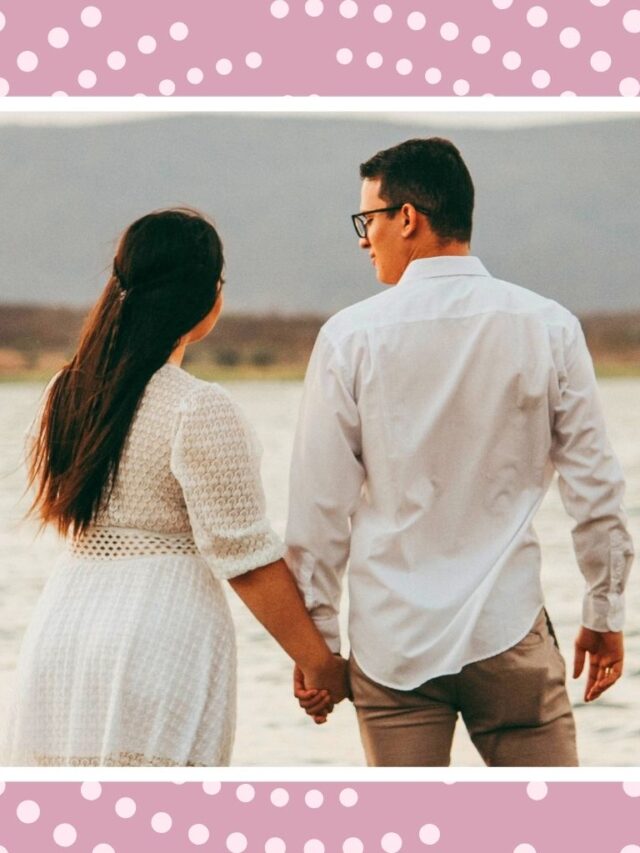 Expecting couple walking by the water for a calm babymoon before baby arrives.