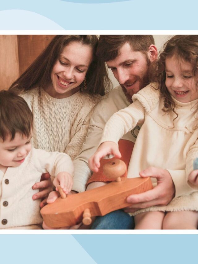Parents and two children enjoying a screen-free family activity with wooden toys at home.