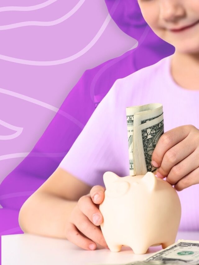 Little girl adding money to a piggy bank.
