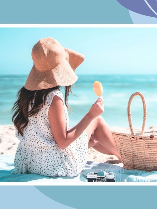 Woman relaxing on a sandy beach with a sun hat and beach bag, representing family-friendly beach vacations and relaxing coastal getaways.