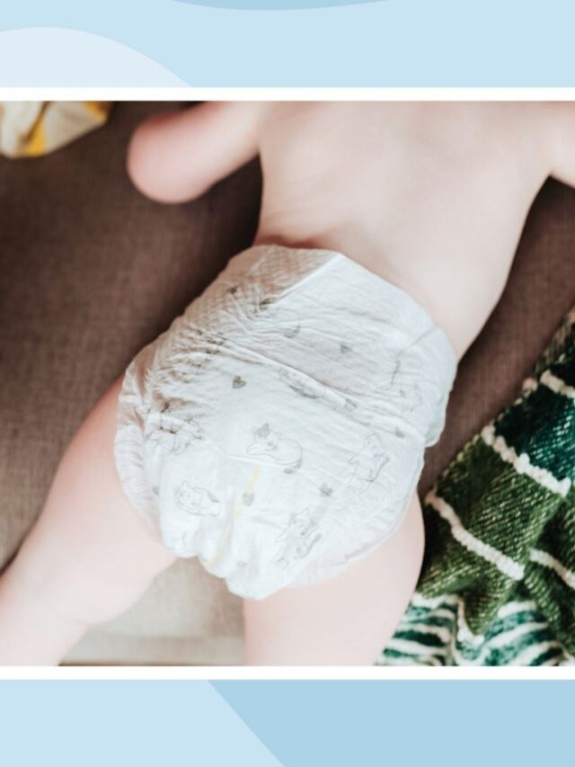 Baby on its tummy wearing a diaper with a green striped cloth.