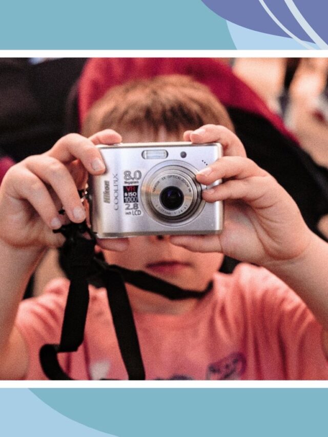 Child holding a camera while exploring a family attraction in Canada, highlighting fun and educational travel experiences for kids.