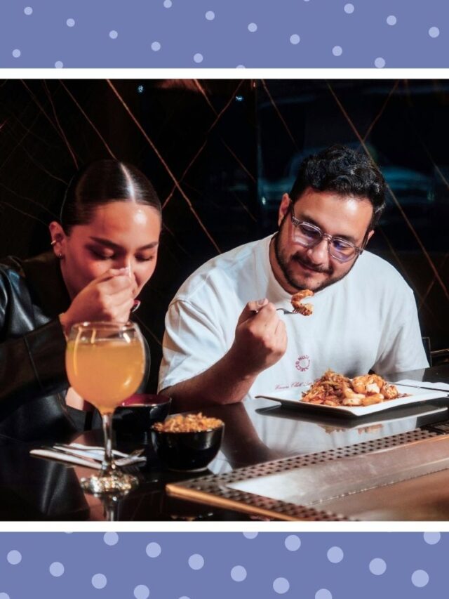 Couple enjoying a cozy restaurant date night with drinks and food, a simple pregnant date night idea before baby arrives.