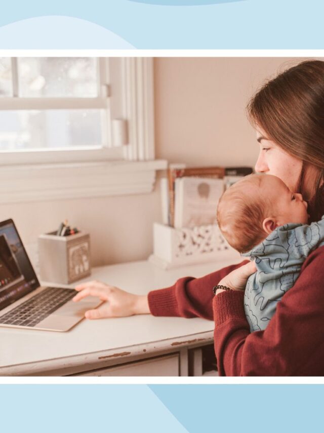 Mother holding her baby during a video call while balancing work and childcare after maternity leave.