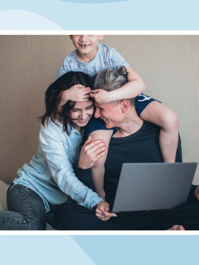 Two parents and their child gathered around a laptop during a family technology learning activity.