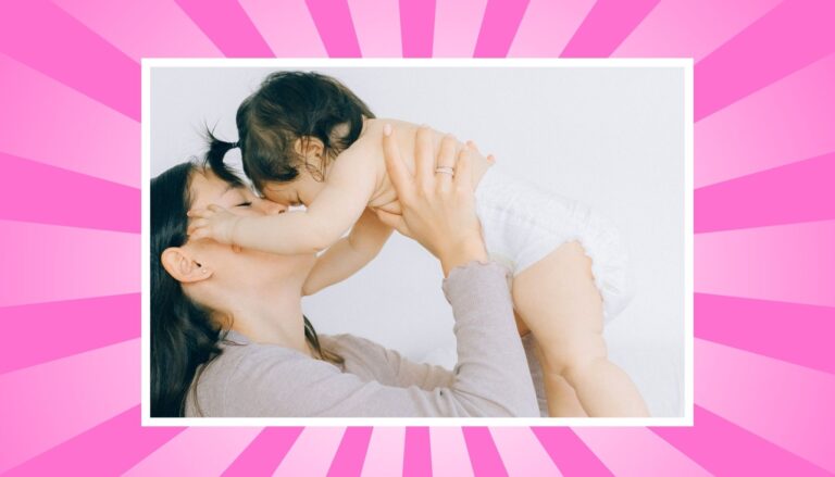 Mom lifting baby during a happy parenting moment while learning how to handle diaper blowouts and messy baby stages.