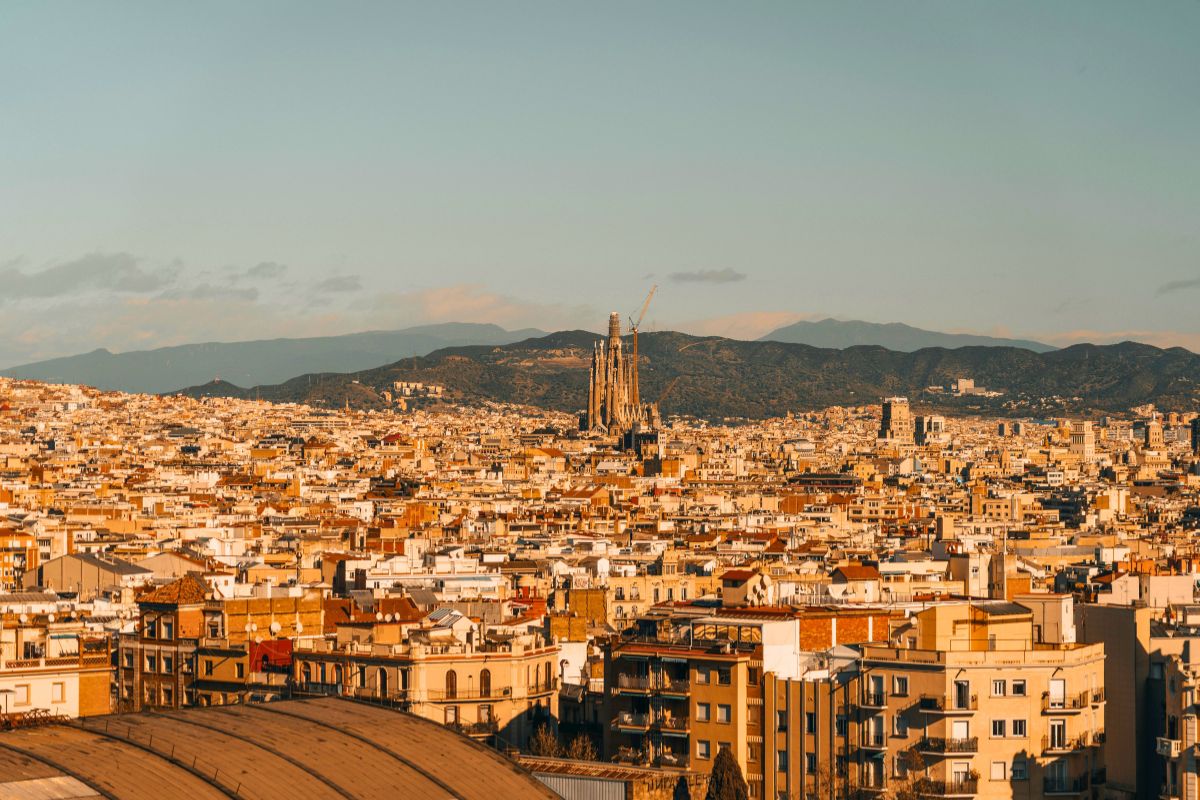 Warm sunset view over Barcelona Spain with the Sagrada Familia visible in the skyline.
