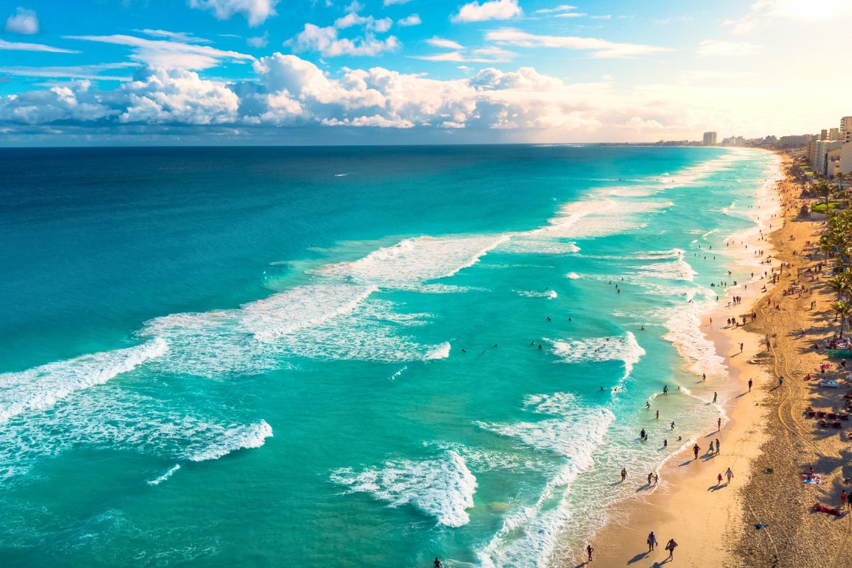 Aerial view of a beautiful turquoise beach coastline, one of the top family-friendly beach vacation destinations.