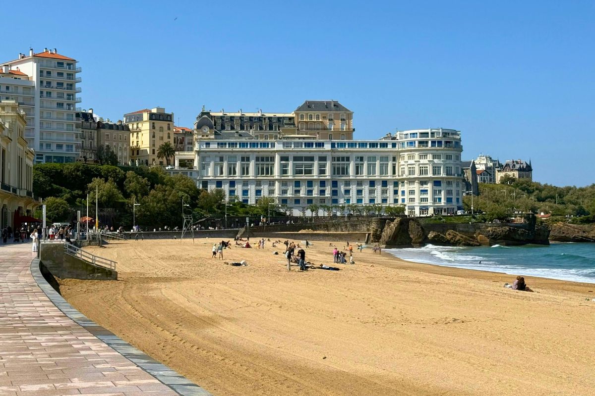 Families enjoying La Grande Plage beach in Biarritz, France, a popular European beach destination for family vacations.