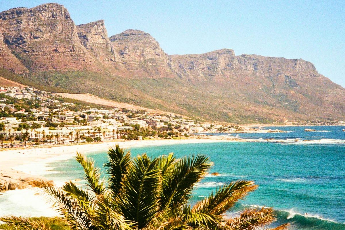 Scenic view of Camps Bay Beach in Cape Town, South Africa, with Table Mountain in the background.