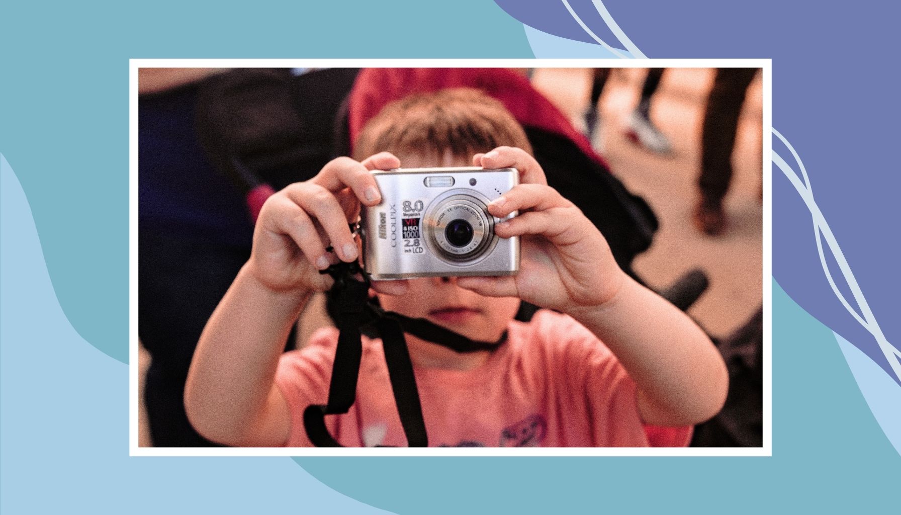 Child holding a camera while exploring a family attraction in Canada, highlighting fun and educational travel experiences for kids.