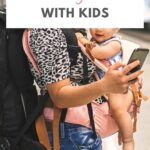 Parent carrying a baby while traveling, representing why Canada is a family-friendly destination for parents with young children.