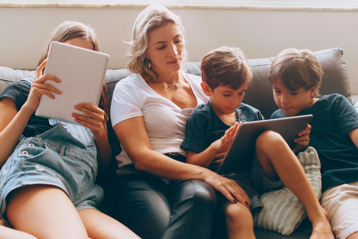 Family using tablets together while practicing balanced screen time habits.