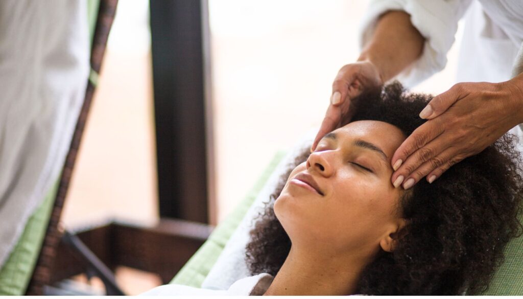 Pregnant woman having a head massage.