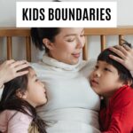 Parent calmly comforting two children while teaching boundaries and positive discipline at home.