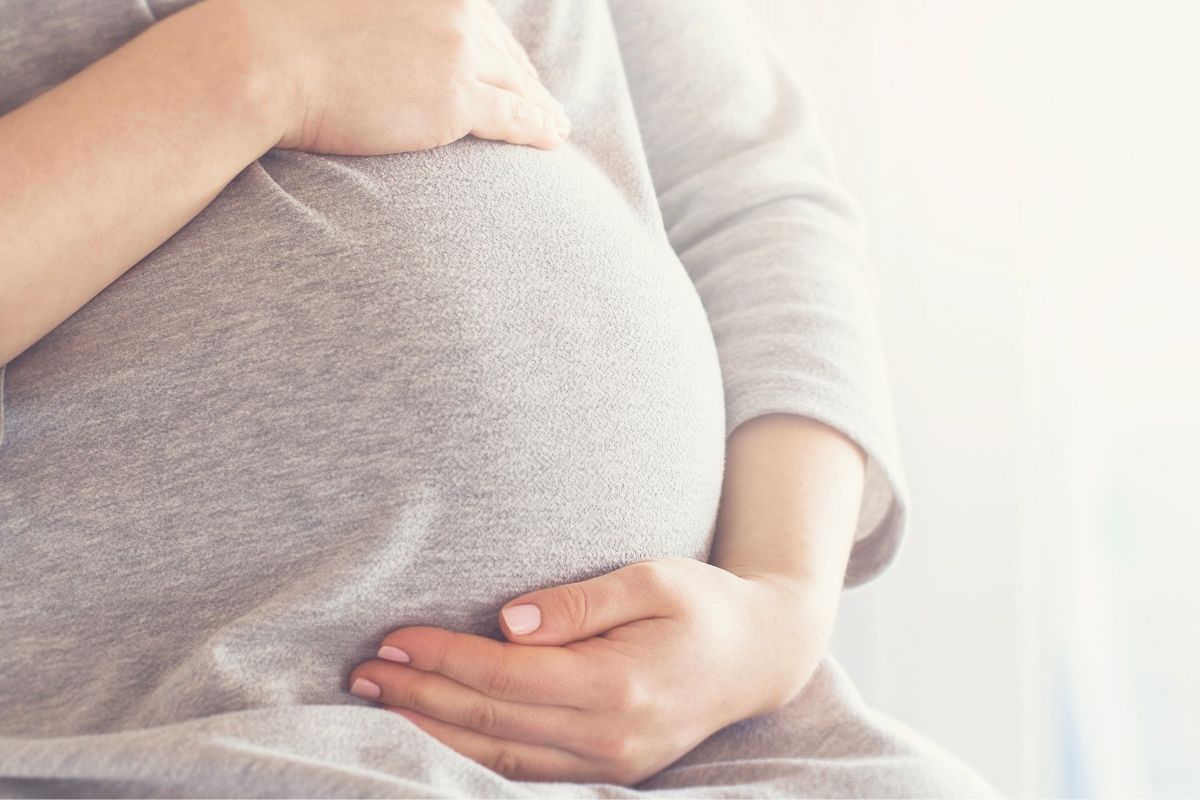 Close-up of pregnant belly during pregnancy preparation for first time parents.