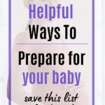 Pregnant woman holding her baby bump while standing near a bright window at home.