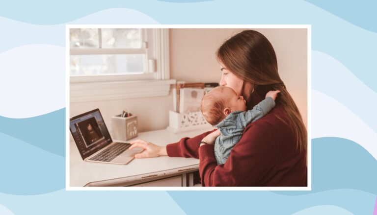 Mother holding her baby during a video call while balancing work and childcare after maternity leave.