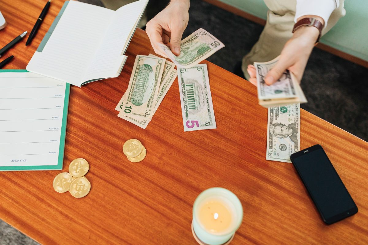 Counting cash for realistic grocery saving and family budgeting habits.