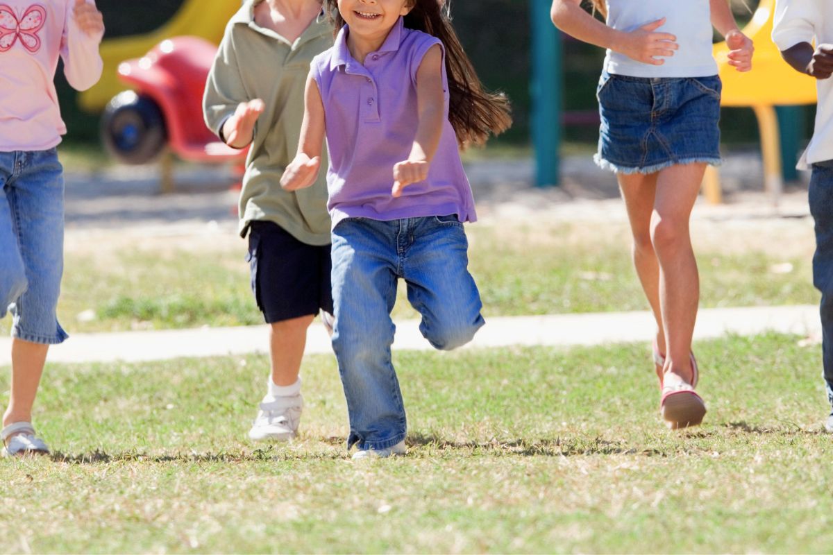 Children running and playing outside during summer family fun activities.