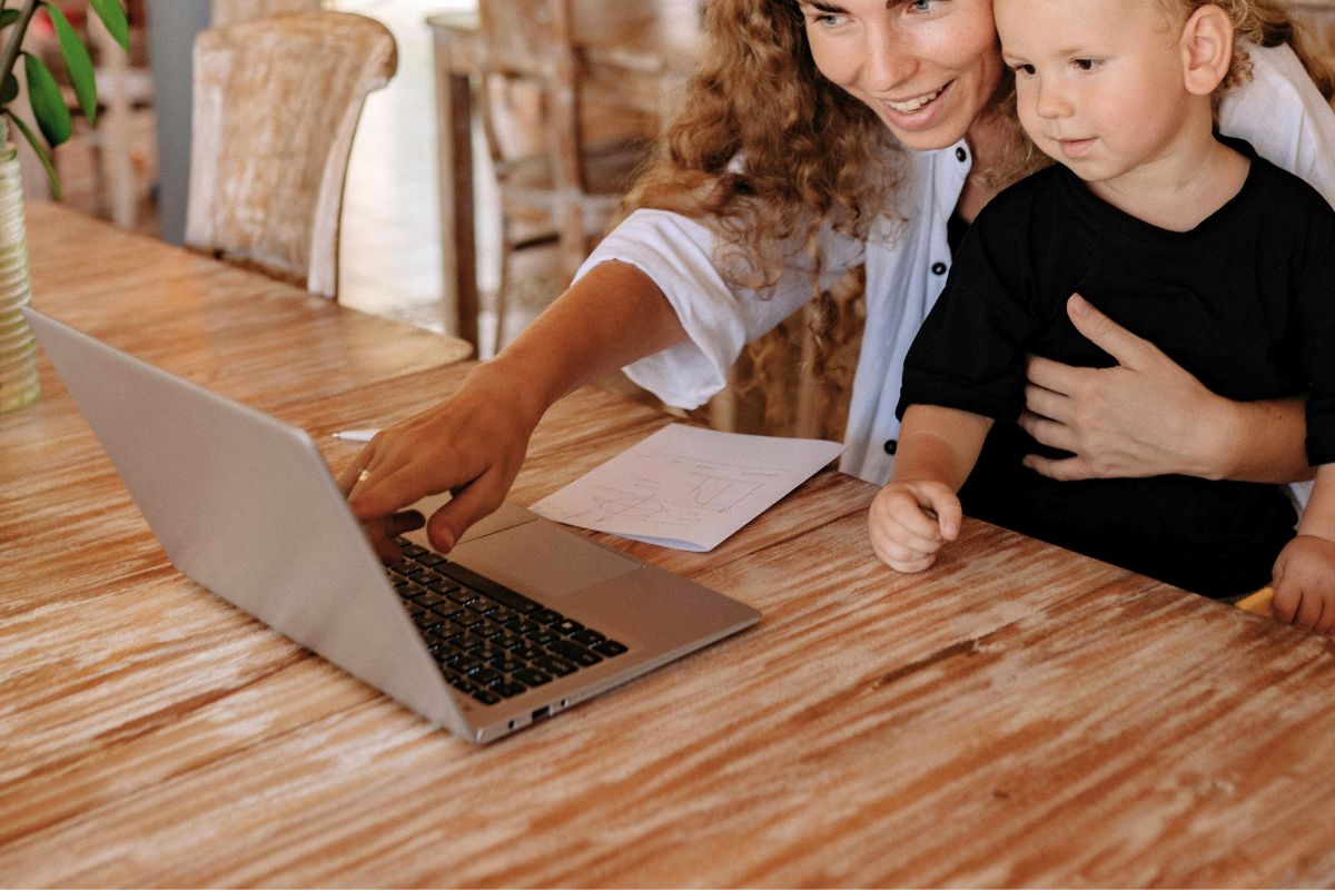 A parent compares back-to-school supplies online with a child before choosing items for delivery or store pickup.
