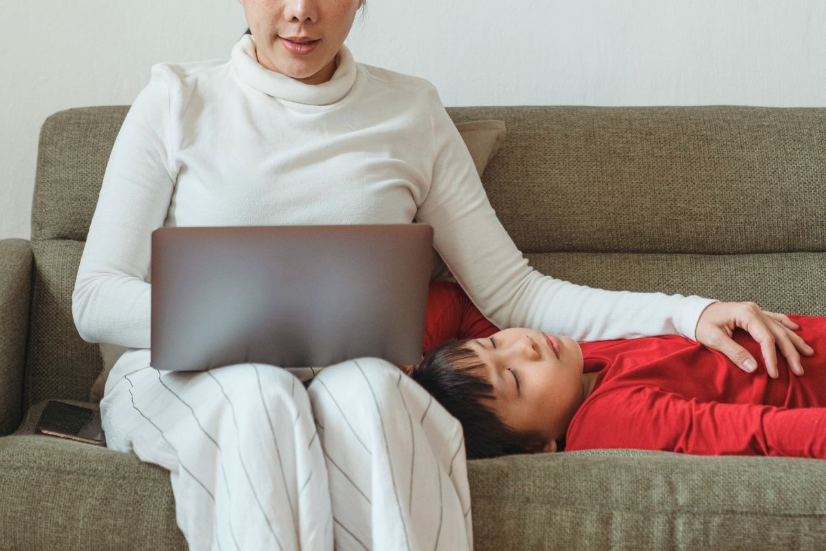 Parent using ChatGPT prompts for parents on a laptop while spending quiet time with a child at home.