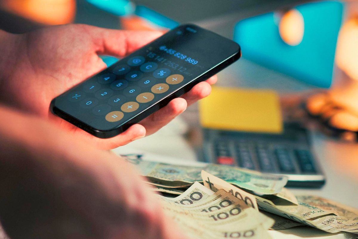 Using a phone calculator to manage bills, savings, and personal finances.