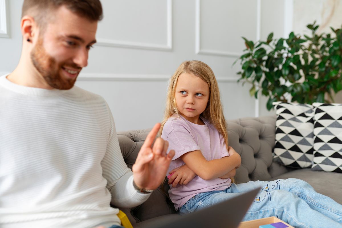 Father talking with his daughter at home during a discussion.