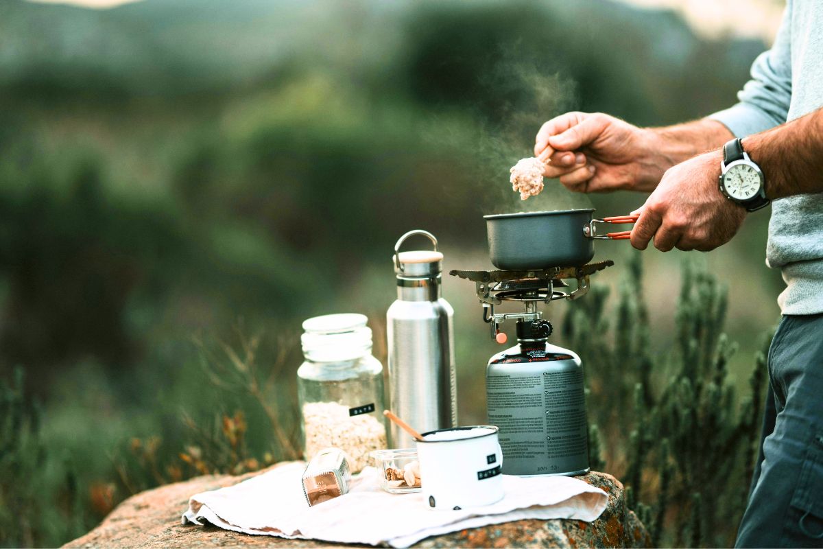 Camping cooking setup with portable stove and simple meal prep for family camping with kids.