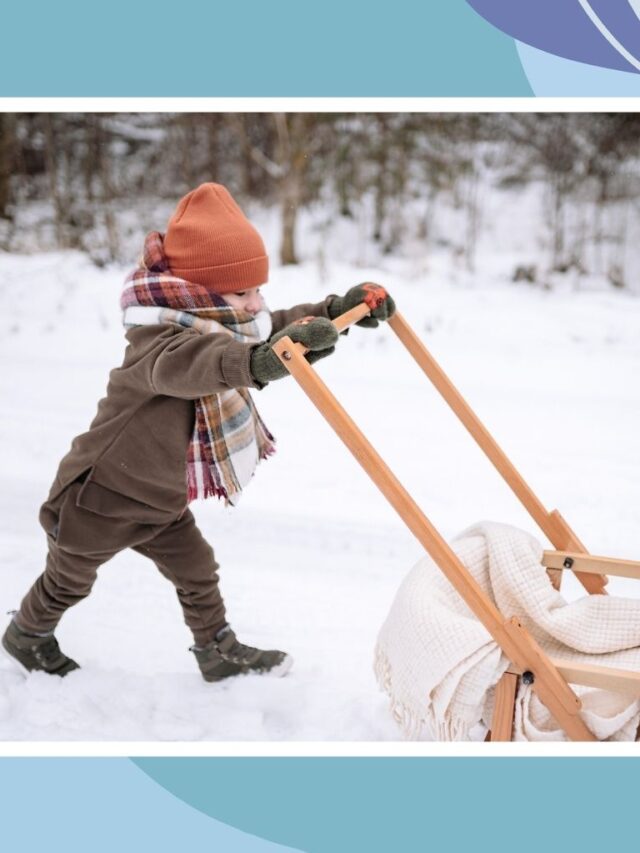 Child dressed in warm winter layers pushing a sled in the snow, showing smart packing and staying warm during winter travel with kids.