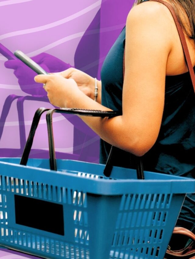 Mom checking budget on phone while grocery shopping with basket.