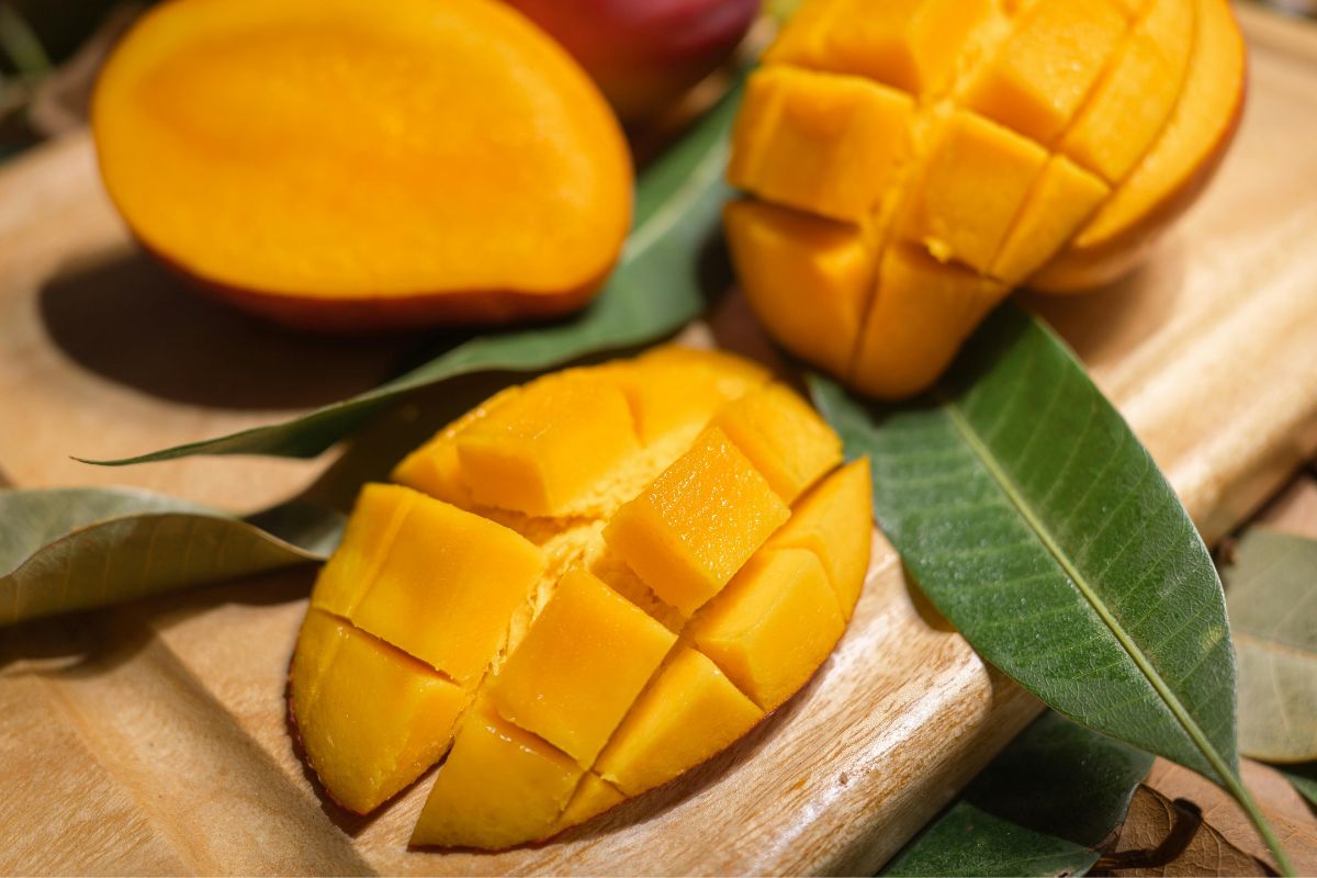 Fresh sliced mango on a cutting board, an easy and natural toddler snack for travel and on-the-go eating.