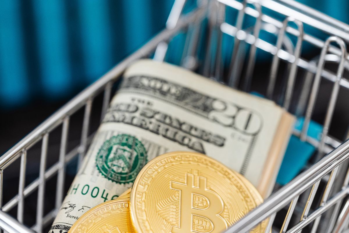 Money in mini cart showing budgeting choices during grocery shopping.