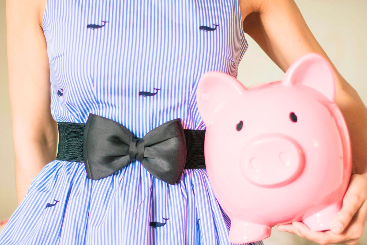 Child holding a piggy bank, learning money habits and saving for something they want.