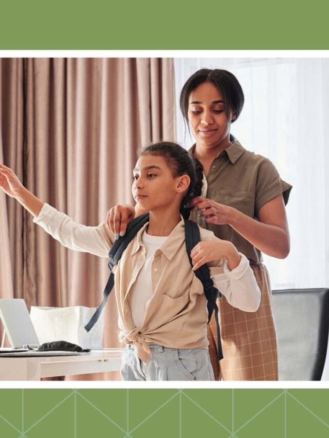 Mother helping her school-age daughter put on a backpack before school.